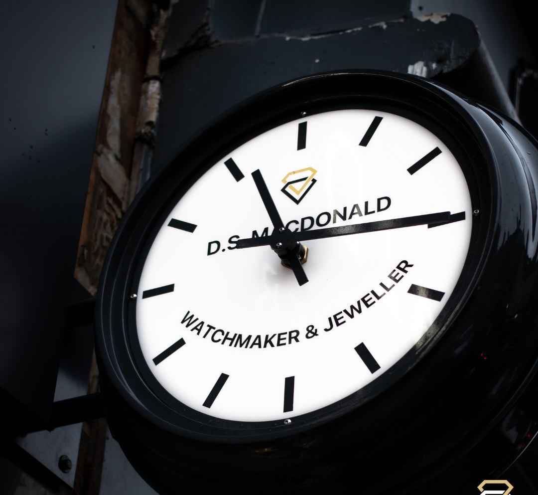 The D.S. MacDonald shop clock, white dial reading Watchmaker and Jeweller